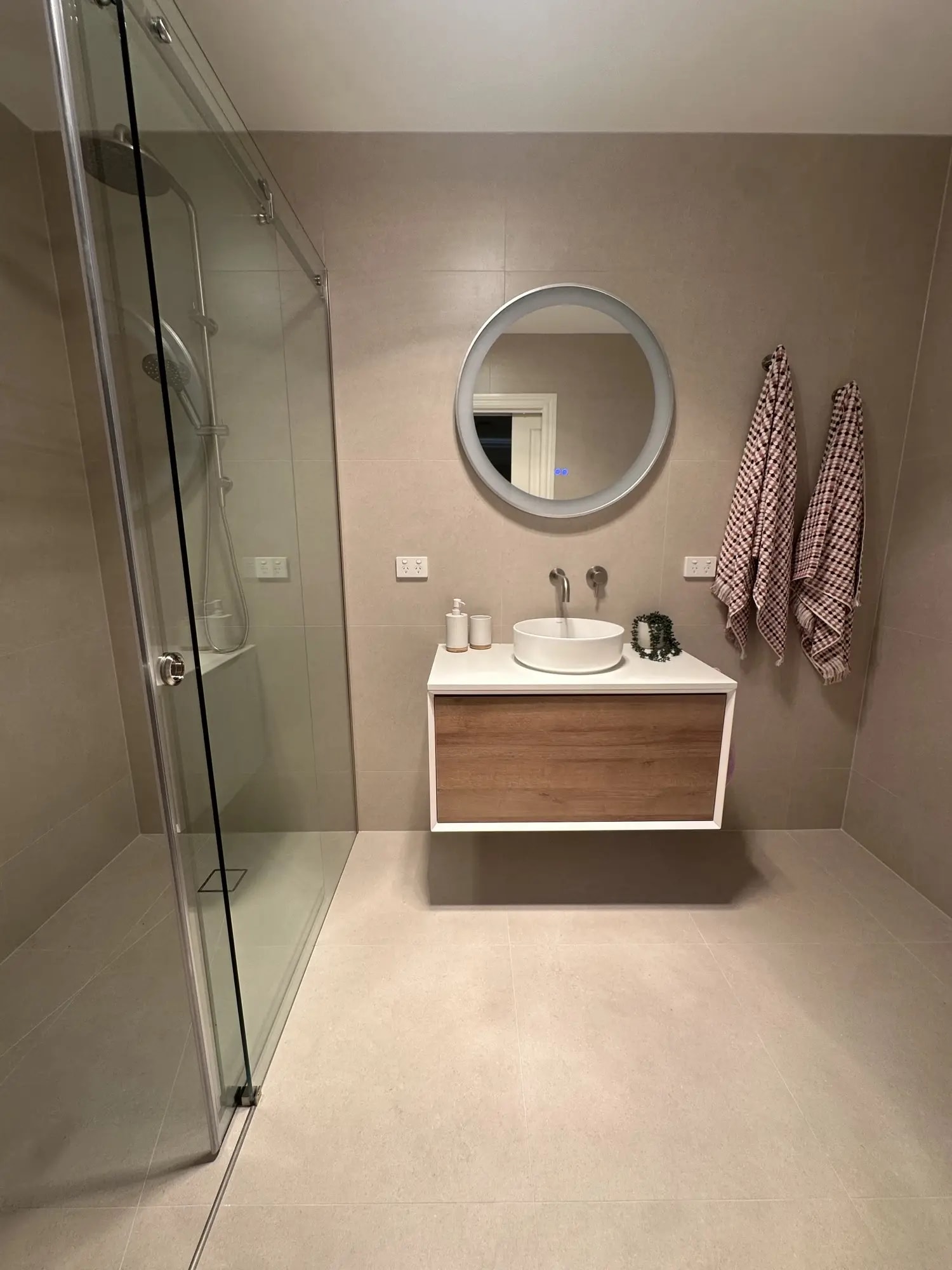 Glenroy ensuite renovation with modern glass shower screen and floor-to-ceiling tiles by DWS Building Co
